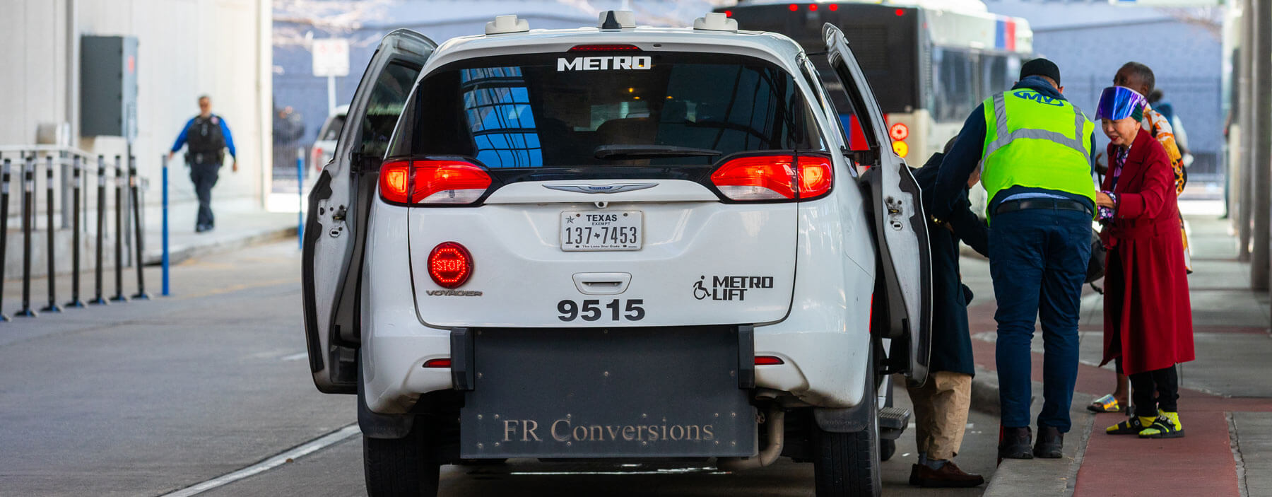 METRO employee assisting a customer get on board a METROLift van.