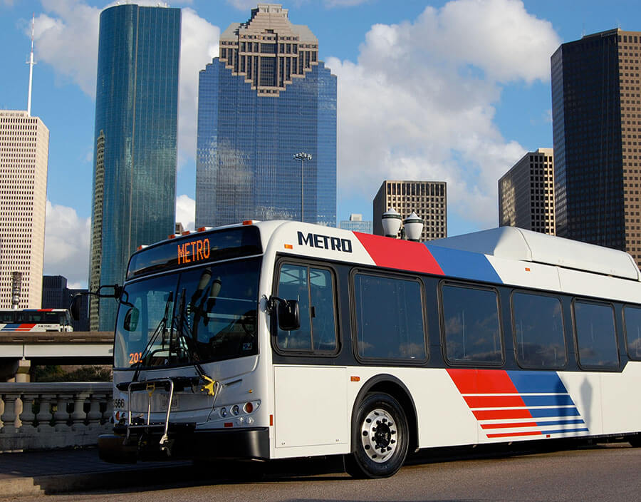 METRO local bus in front of the Houston skyline